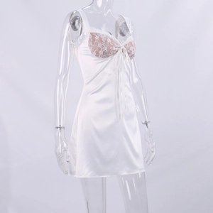 Close-up of white satin slip dress with delicate floral lace neckline and bow detail