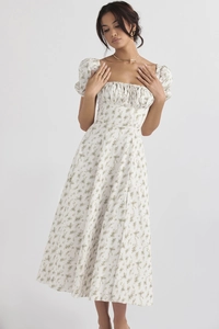 Detailed close-up of floral print and puff sleeves on white square neck midi dress
