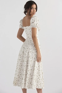 Detail of floral print maxi dress featuring back square neck and puff short sleeves