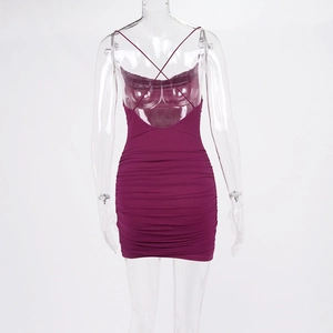 Detail of cross-back straps and ruched fabric on a plum backless mini dress