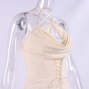 Detailed view of apricot halter mini dress with crisscross waist ties and draped neckline