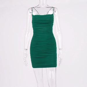 Detail of green ruched bodycon mini dress featuring thin straps and textured fabric