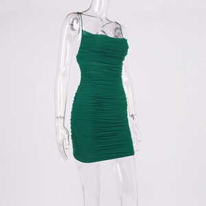 Detail of green bodycon dress featuring elastic ruched fabric and slim fit design