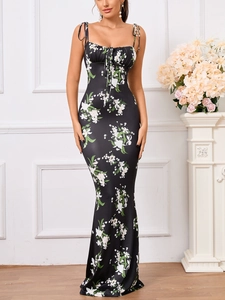 Detail of floral maxi dress showing tie-up shoulder straps and ruched bodice design