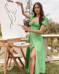 Detailed view of puff sleeves and floral print on a green French-style split midi dress