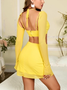 Detail of lemon yellow mesh skirt set showing halter back and metal zipper closure