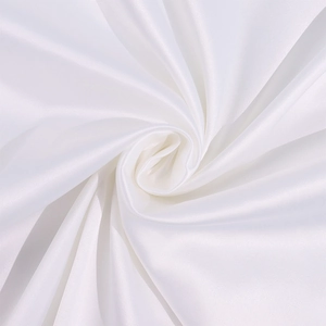 Detailed view of high-gloss white satin fabric with elegant spiral draping and silky texture