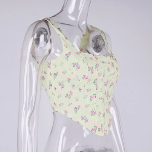 Detail of square neck floral corset top with curved hem and pink flower patterns