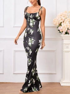 Detail of floral print on backless maxi dress with tie-up straps and fishtail hemline
