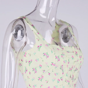 Detailed view of yellow floral corset top with pink flower print and bone structure