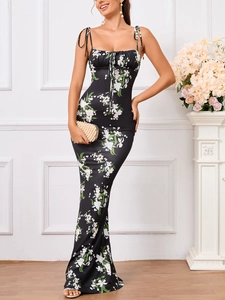 Detail of adjustable drawstring neckline and bow straps on black floral fishtail dress