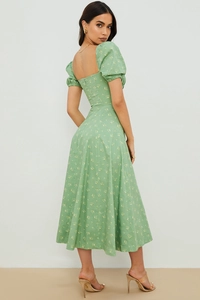 Detail of light green floral dress showing vintage puff sleeves and square neckline