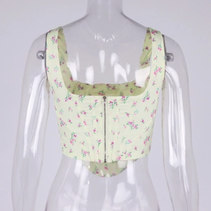 Detail view of the metal zipper closure and floral print on the back of corset top