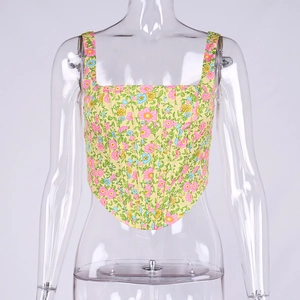 Detailed view of yellow floral corset top with fishbone structure and curved hem
