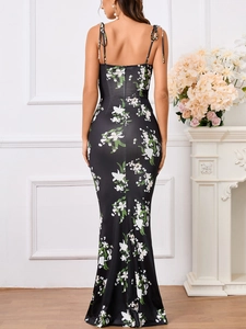 Detail of floral backless long dress featuring delicate straps and fishtail silhouette