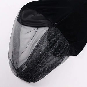 Detail of black velvet dress with shimmering silver sequins on sheer mesh and hidden zipper