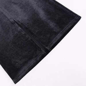 Detailed close-up of high-quality black velvet dress fabric with side slit stitching