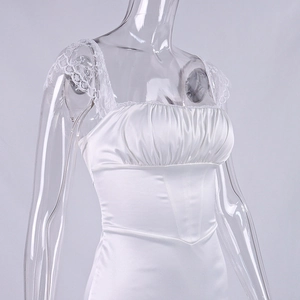Close-up of white satin dress with delicate lace shoulders and ruched bust detail