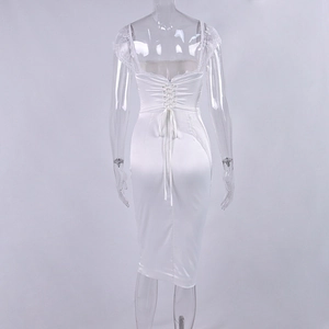Detailed back view of a white satin dress featuring intricate lace-up ties and lace trim