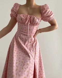 Detail of pink floral French dress with puff sleeves, square neck and thigh-high slit