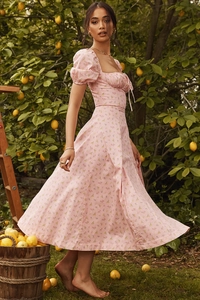 Close-up of pink floral dress featuring puff sleeves and square neckline detail