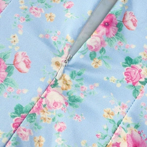 Detail of floral print fabric with hidden zipper closure on summer long fishtail dress