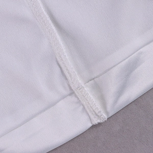 Detail of neat overlock stitching and high-quality white fabric hem on a satin dress