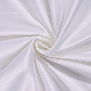 Detail shot of white satin fabric showing soft luster and elegant draped textures