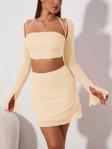 Detail view of stylish three-piece mesh set with halter top, cardigan, and mini skirt