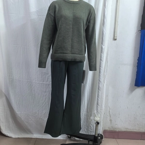 Detail of high-waisted satin wide-leg pants paired with a grey knit long-sleeved sweater