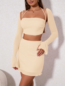 Detail of beige mesh three-piece set with halter top, bodycon skirt and ruffled sleeves