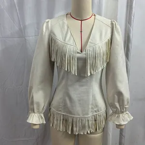 Detailed view of bohemian faux suede V-neck top featuring long fringe tassels and soft fabric