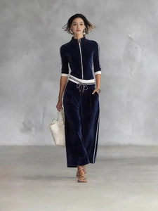Tuta da donna in velluto blu scuro con collo alto a zip e dettagli a righe bianche