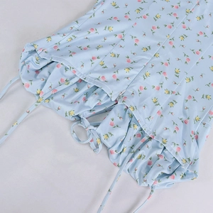 Close-up of light blue floral dress showing shirred detail and invisible zipper