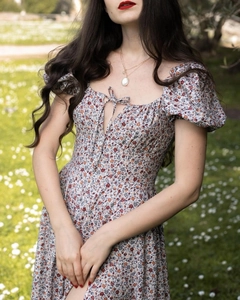 Detail of floral print dress with square neckline, drawstring tie and puff sleeves