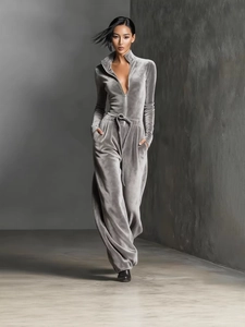 Women's grey velvet jumpsuit with high collar, long sleeves, and wide leg design