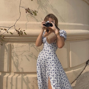Detail of floral print slit dress featuring puff sleeves and square neckline style