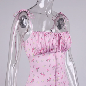Detail view of pink floral ruffled fishtail dress with adjustable bow shoulder straps