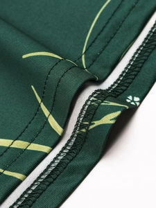 Detailed close-up of double-needle stitching and seam work on floral green fabric