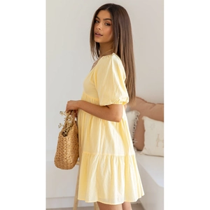 Detail view of the soft yellow cotton fabric and puff sleeves on a summer dress