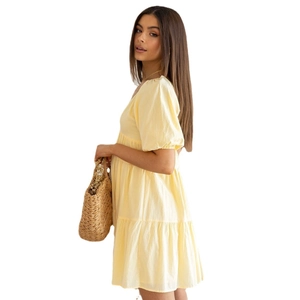 Light yellow summer dress with puff sleeves and tiered skirt for a casual vacation look