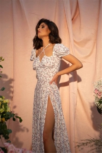 Detailed close-up of floral print dress with puff sleeves and side slit design