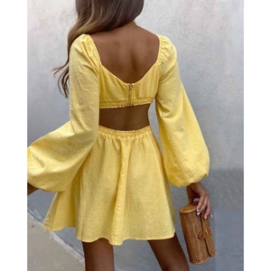Vibrant yellow two-piece set featuring long-sleeve crop top and high-waist A-line skirt