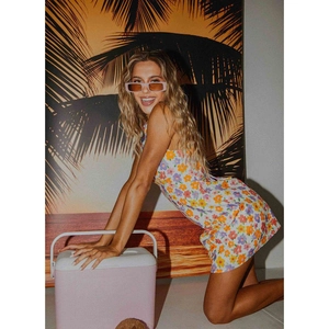 Detailed close-up of a sleeveless floral mini dress featuring a vibrant summer vacation style