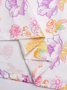 Close-up of floral print fabric showing delicate stitching and soft pleated texture