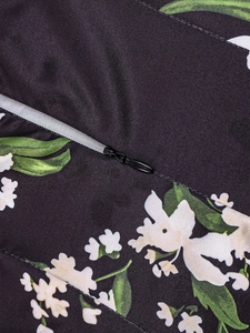Detail of invisible zipper closure on dark floral print backless maxi dress fabric