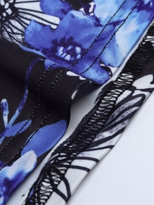 Close-up of double-stitched seams on floral and zebra print stretchy fabric