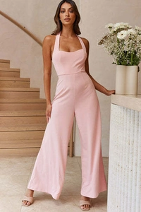Detail of elegant pink halter neck jumpsuit with wide leg design and smooth fabric