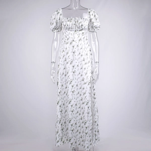 Detail of floral print maxi dress featuring square neck, puffed sleeves, and side slit