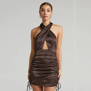 Detail of chocolate brown satin dress showing crossover halter neck and ruched texture